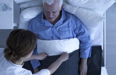 Shot of a nurse checking on her senior patient