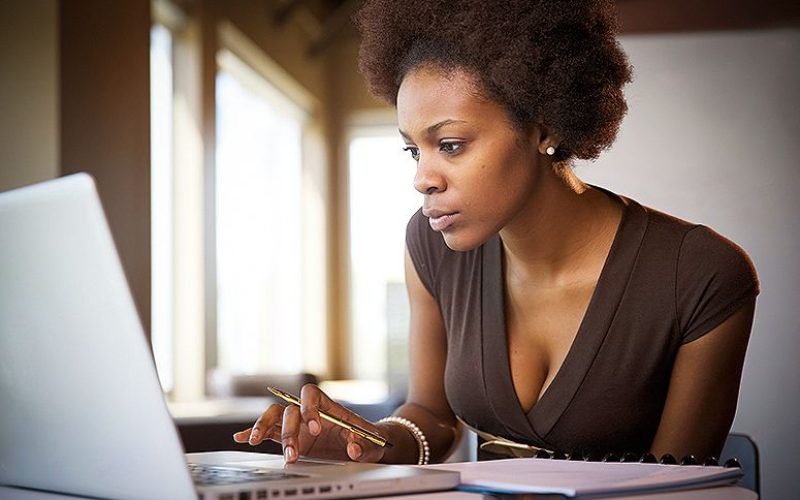 blackwoman-tech-at-desk-searching-on-laptop