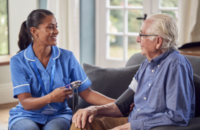 senior-man-at-home-in-lounge-having-blood-pressure-2022-04-04-21-27-31-utc-scaled